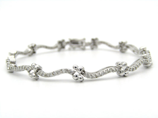 18K gold diamond wave link bracelet.