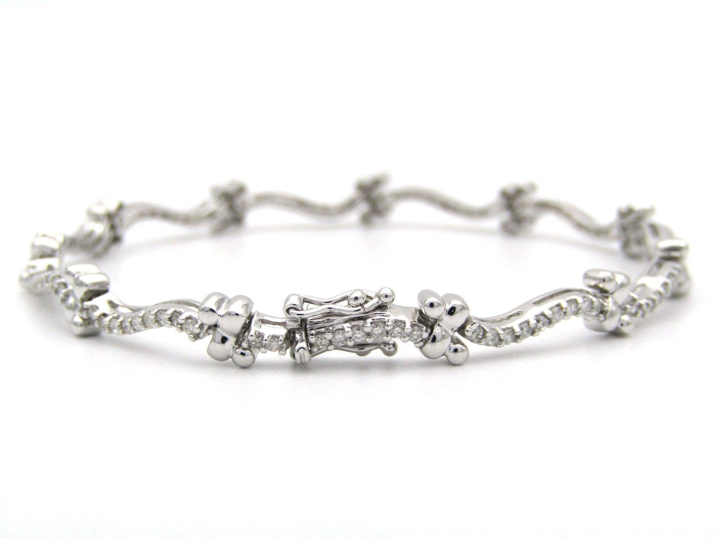 18K gold diamond wave link bracelet.