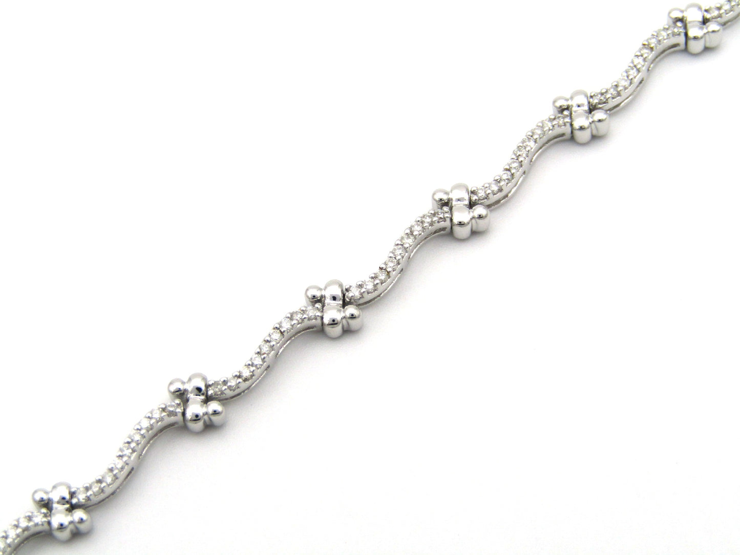 18K gold diamond wave link bracelet.