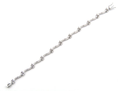 18K gold diamond wave link bracelet.