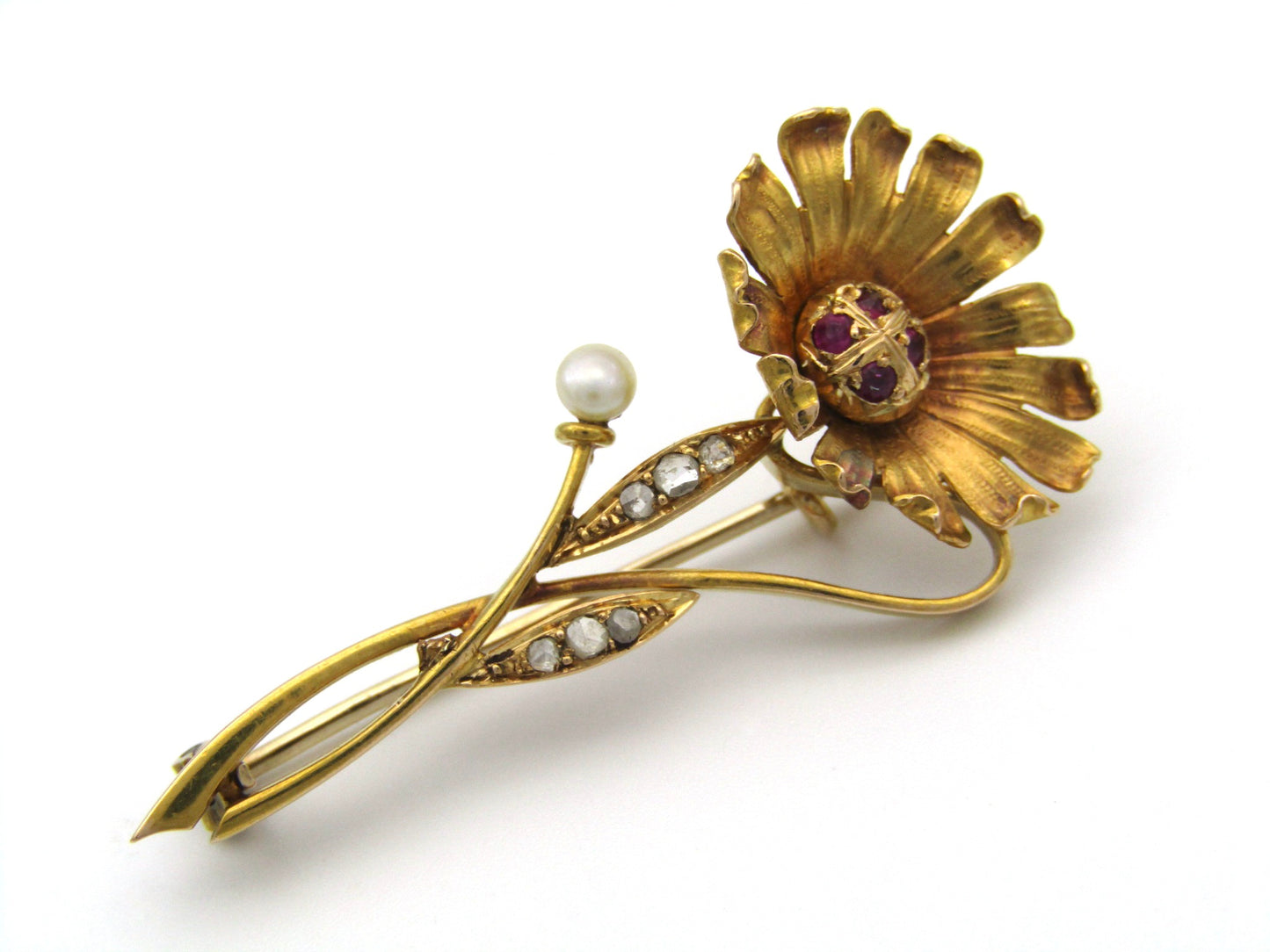 22K gold Edwardian ruby, diamond, and pearl sunflower brooch, circa 1900.