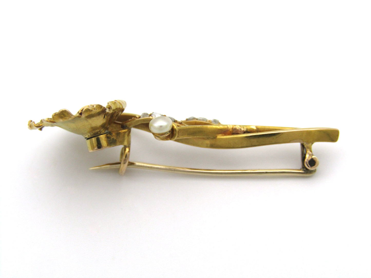 22K gold Edwardian ruby, diamond, and pearl sunflower brooch, circa 1900.