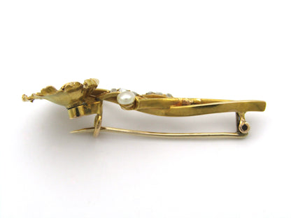 22K gold Edwardian ruby, diamond, and pearl sunflower brooch, circa 1900.