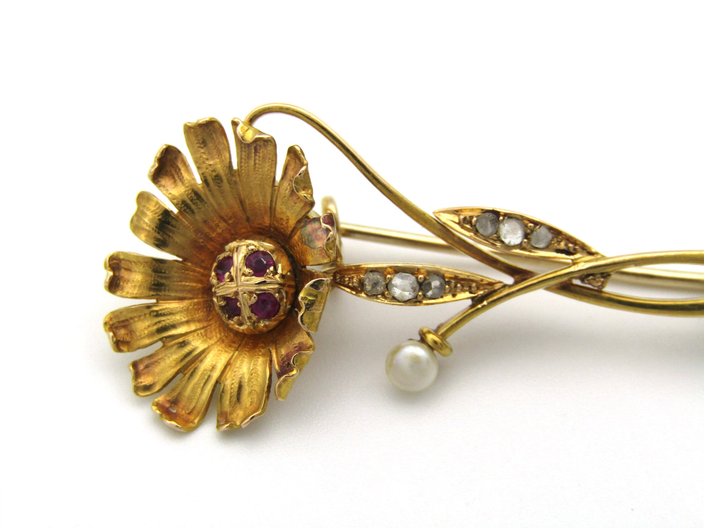 22K gold Edwardian ruby, diamond, and pearl sunflower brooch, circa 1900.
