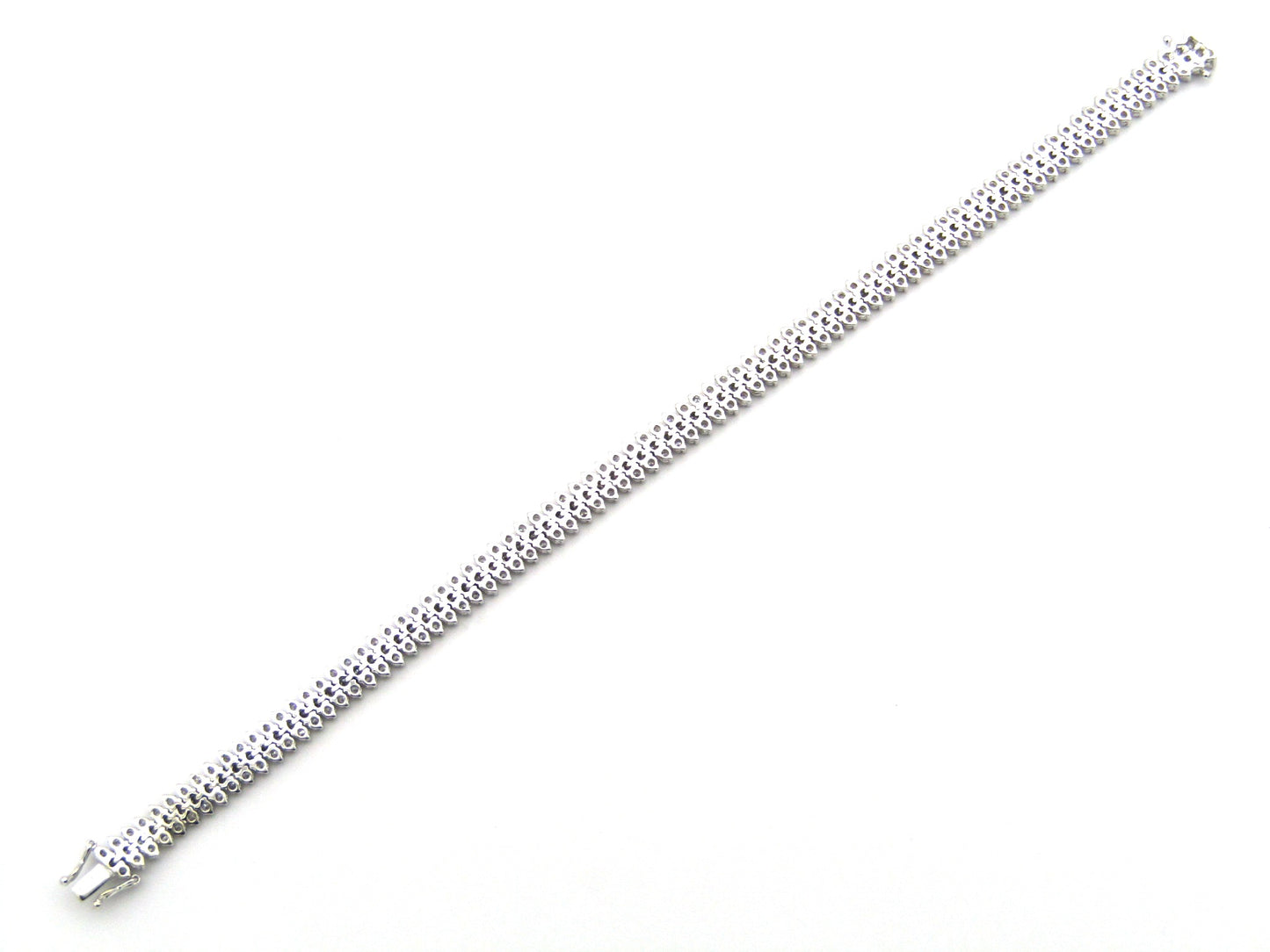 18K gold triple row diamond tennis bracelet.
