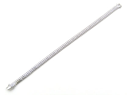 18K gold triple row diamond tennis bracelet.