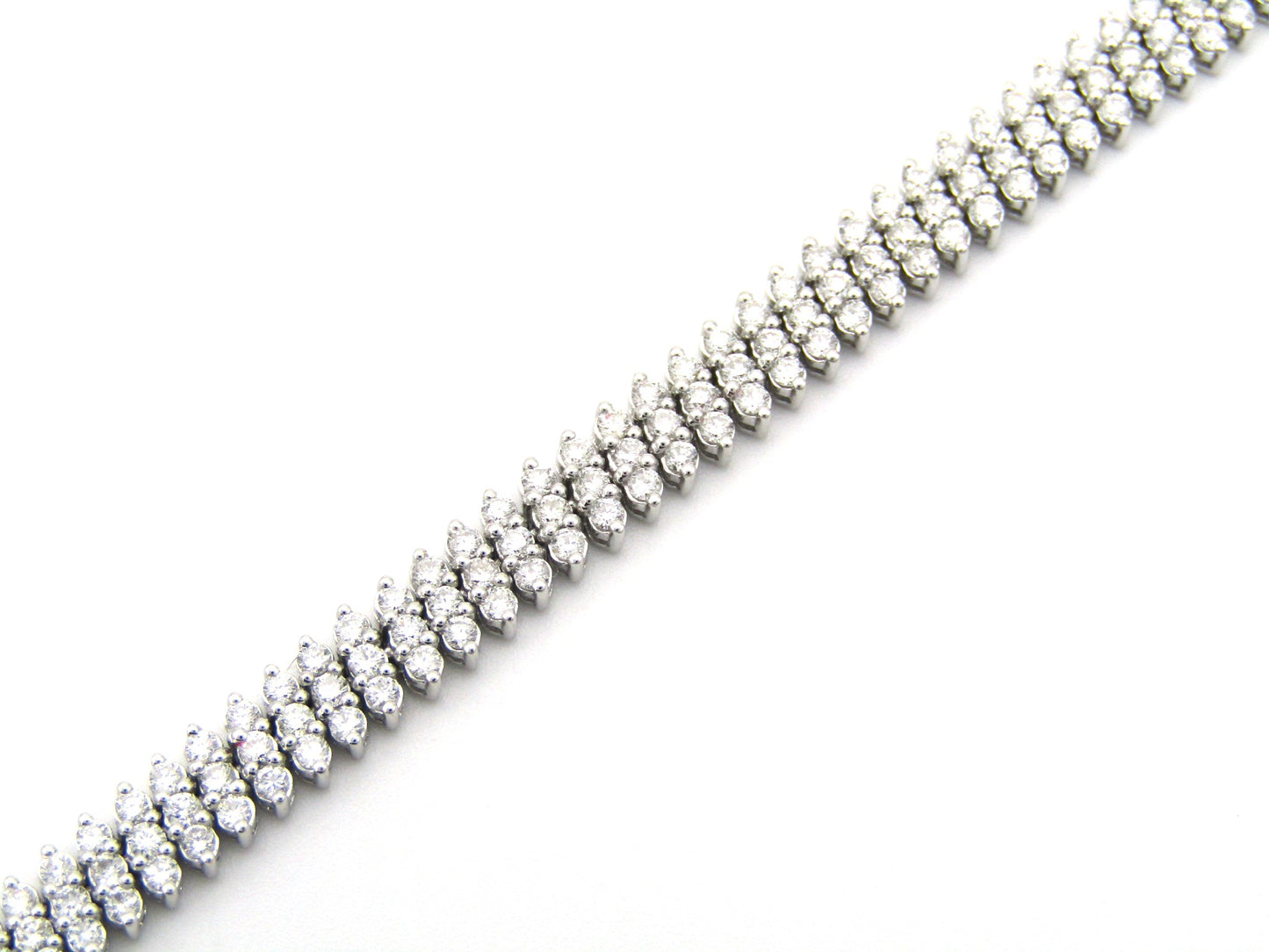 18K gold triple row diamond tennis bracelet.