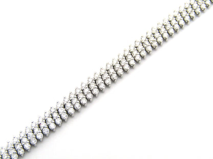 18K gold triple row diamond tennis bracelet.