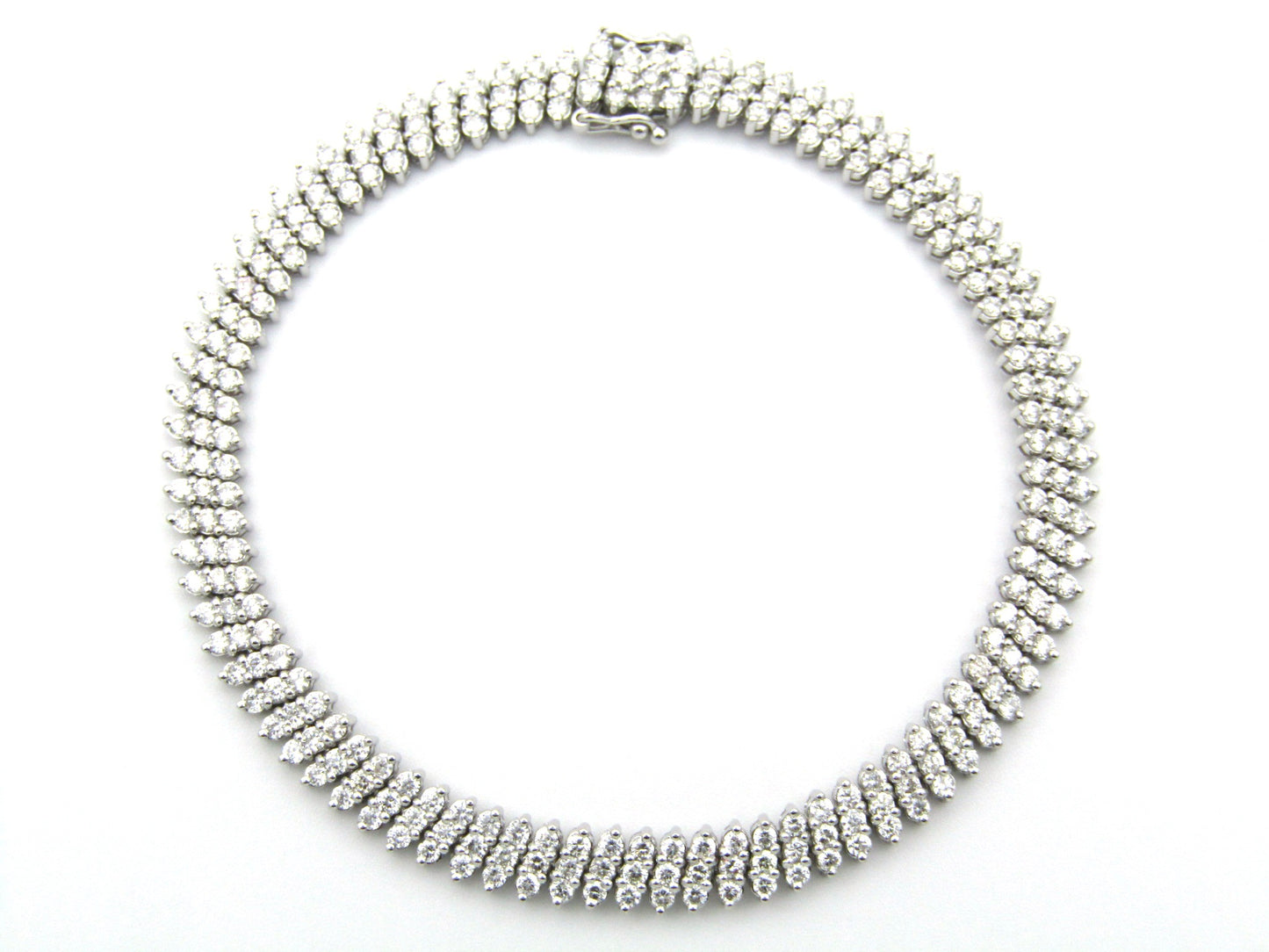 18K gold triple row diamond tennis bracelet.