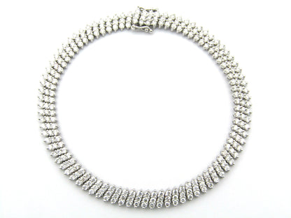 18K gold triple row diamond tennis bracelet.