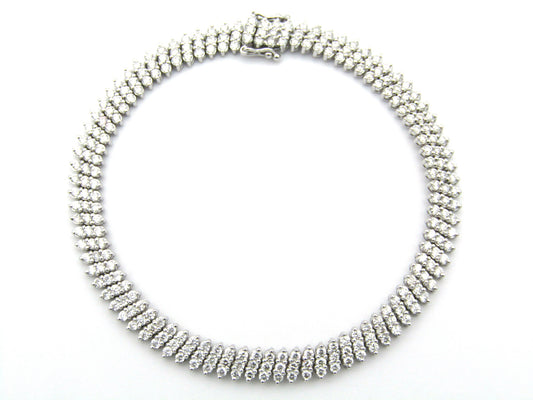 18K gold triple row diamond tennis bracelet.