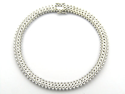 18K gold triple row diamond tennis bracelet.