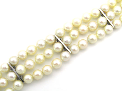 18K gold three-strand akoya cultured pearl bracelet, circa 1980's.