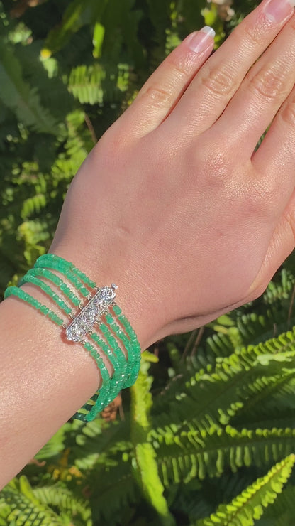 14K gold diamond and 5 strand emerald bracelet.