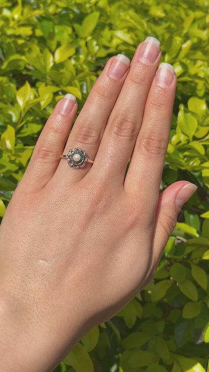 9K gold Edwardian pearl, emerald, and diamond flower ring.