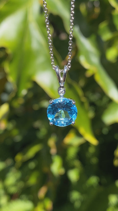 9K gold blue topaz and diamond pendant.