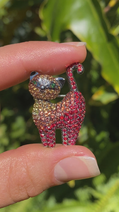 18K gold fancy sapphire, tsavorite garnet and diamond cat pendant/brooch.