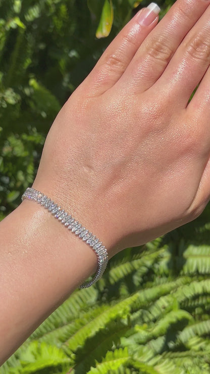 18K gold triple row diamond tennis bracelet.