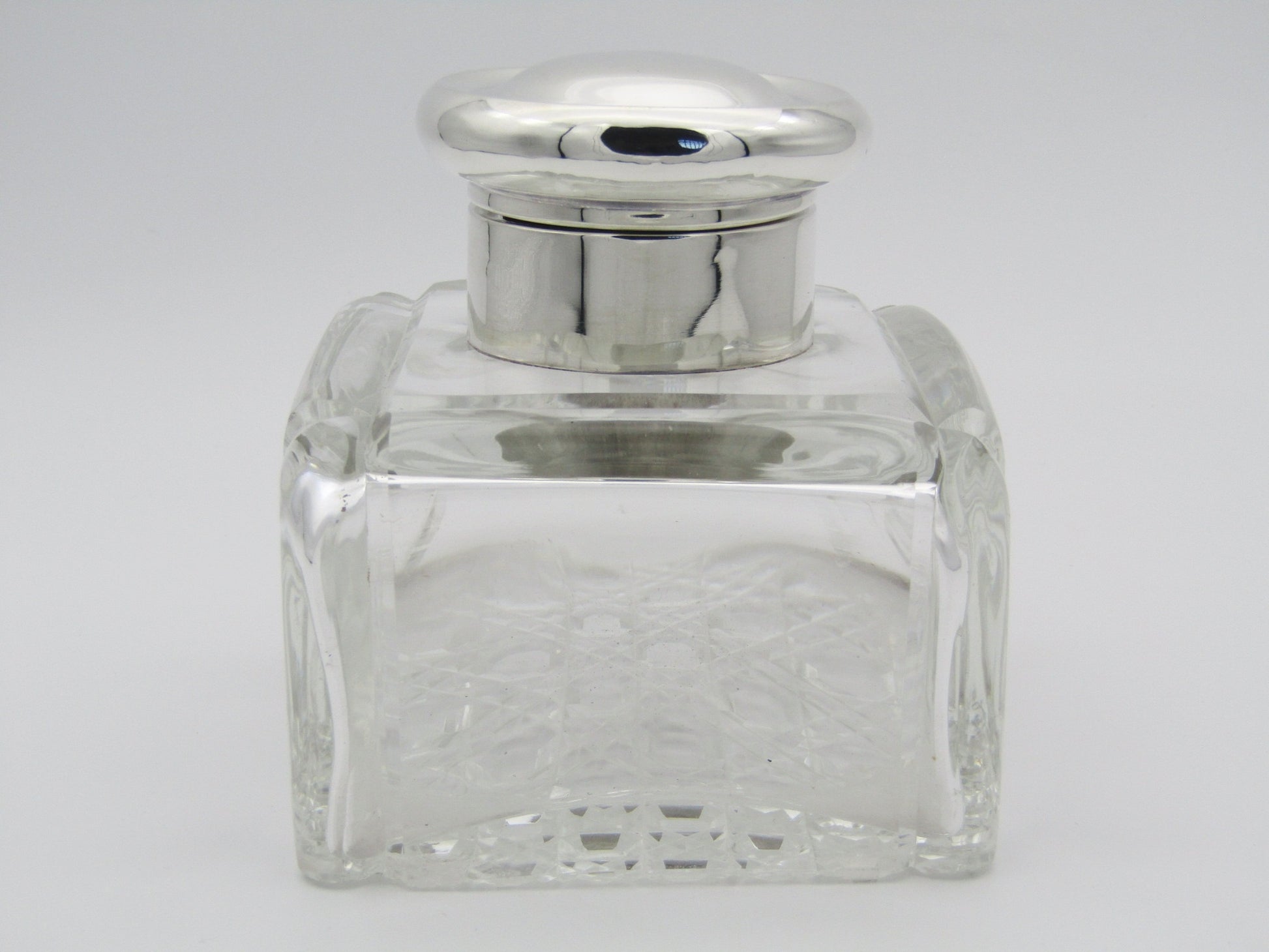 A silver mounted and cut glass desk inkwell by Asprey & Co. Ltd, Birmingham, 1915.