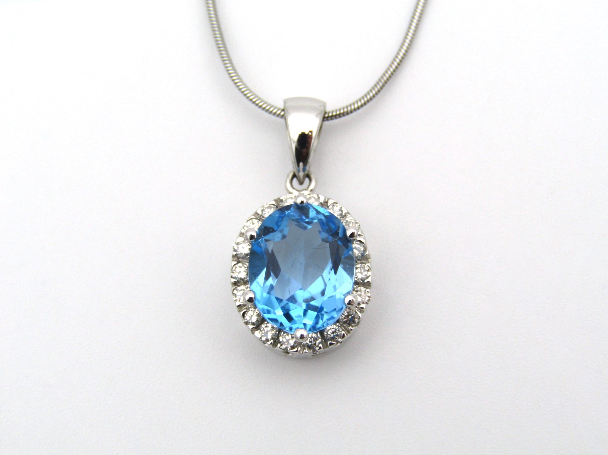 9K gold blue topaz and diamond pendant.