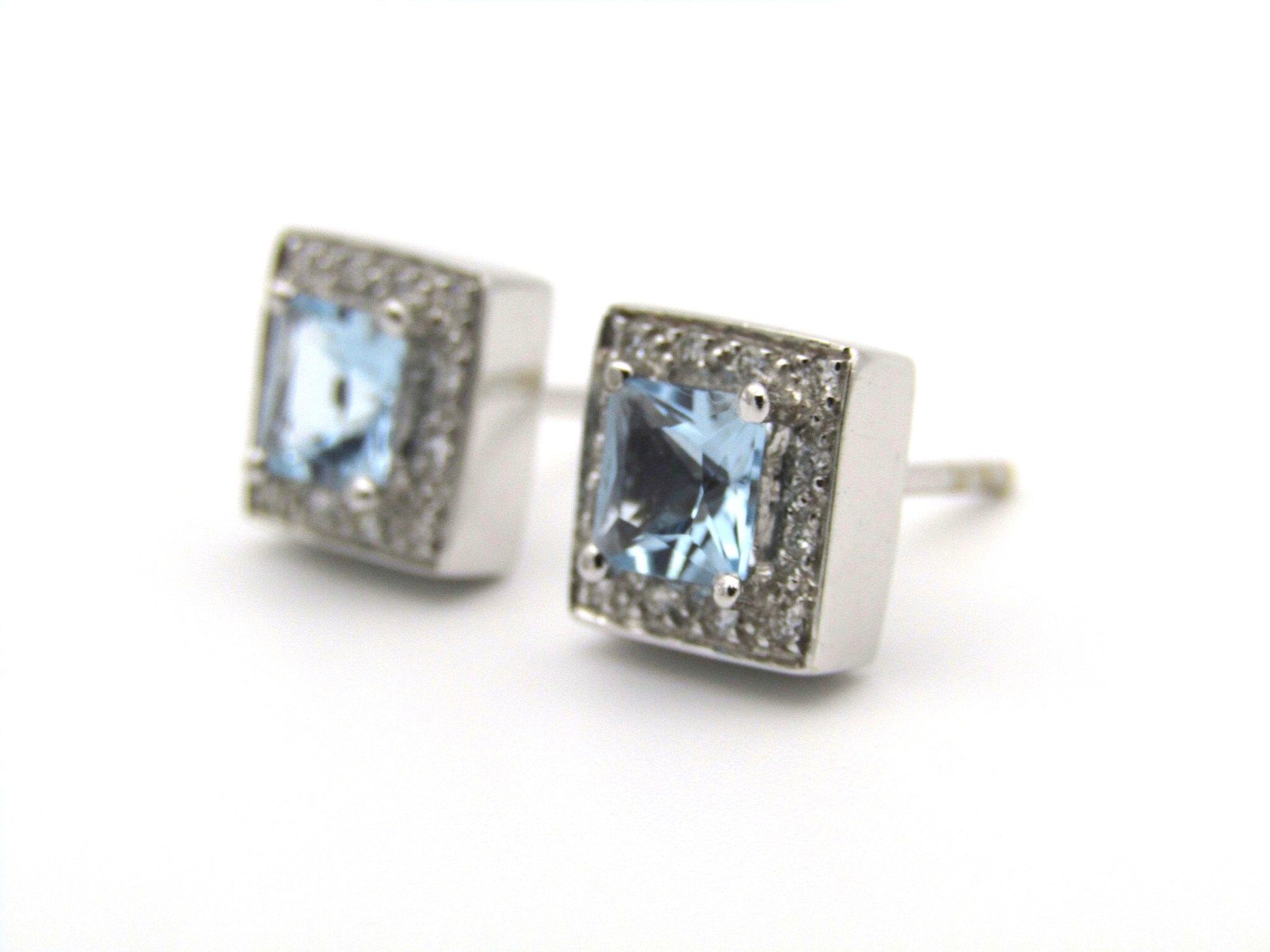 A pair of 18kt gold Blue Topaz and diamond earrings.