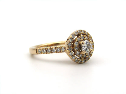 18K gold diamond halo ring.