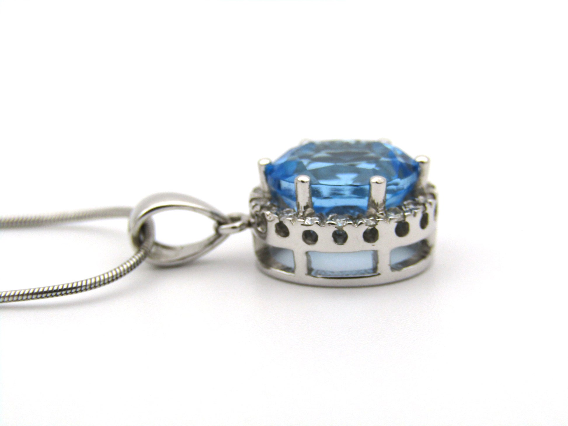 9K gold blue topaz and diamond pendant.