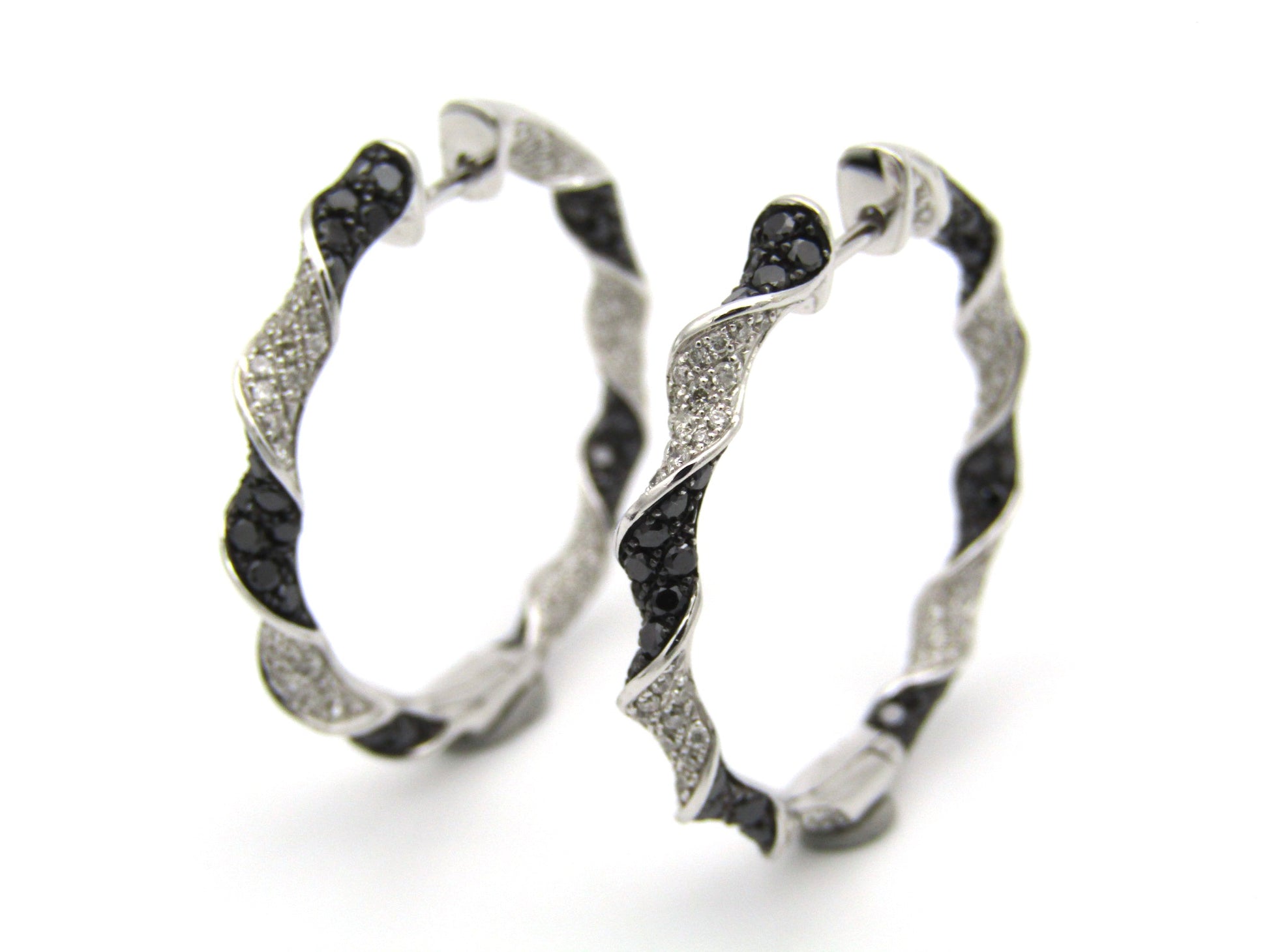 18K gold black and colourless diamond earrings.