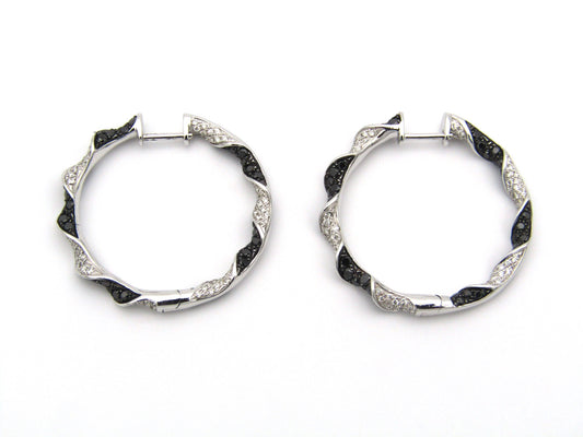 18K gold black and colourless diamond earrings.