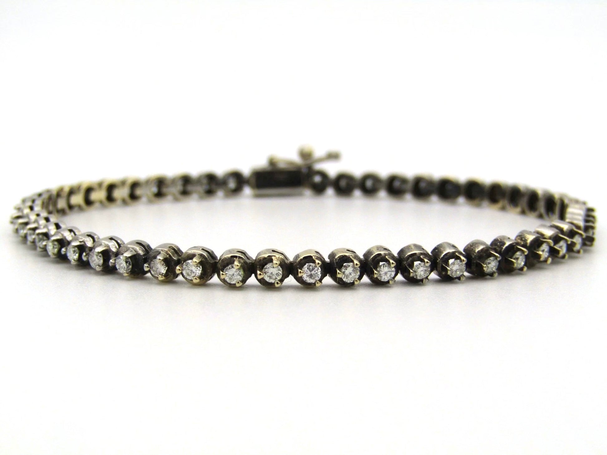 14K gold diamond tennis bracelet.