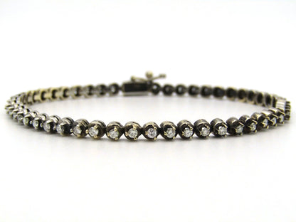 14K gold diamond tennis bracelet.