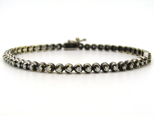 14K gold diamond tennis bracelet.