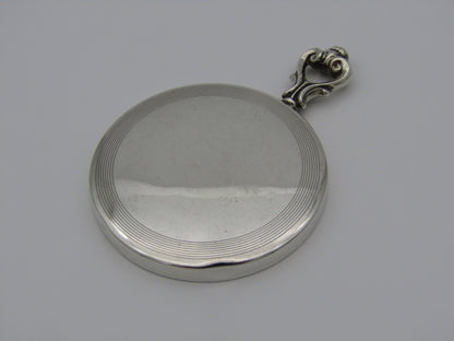 A sterling silver hand mirror by Cartier. Circa 1920s.