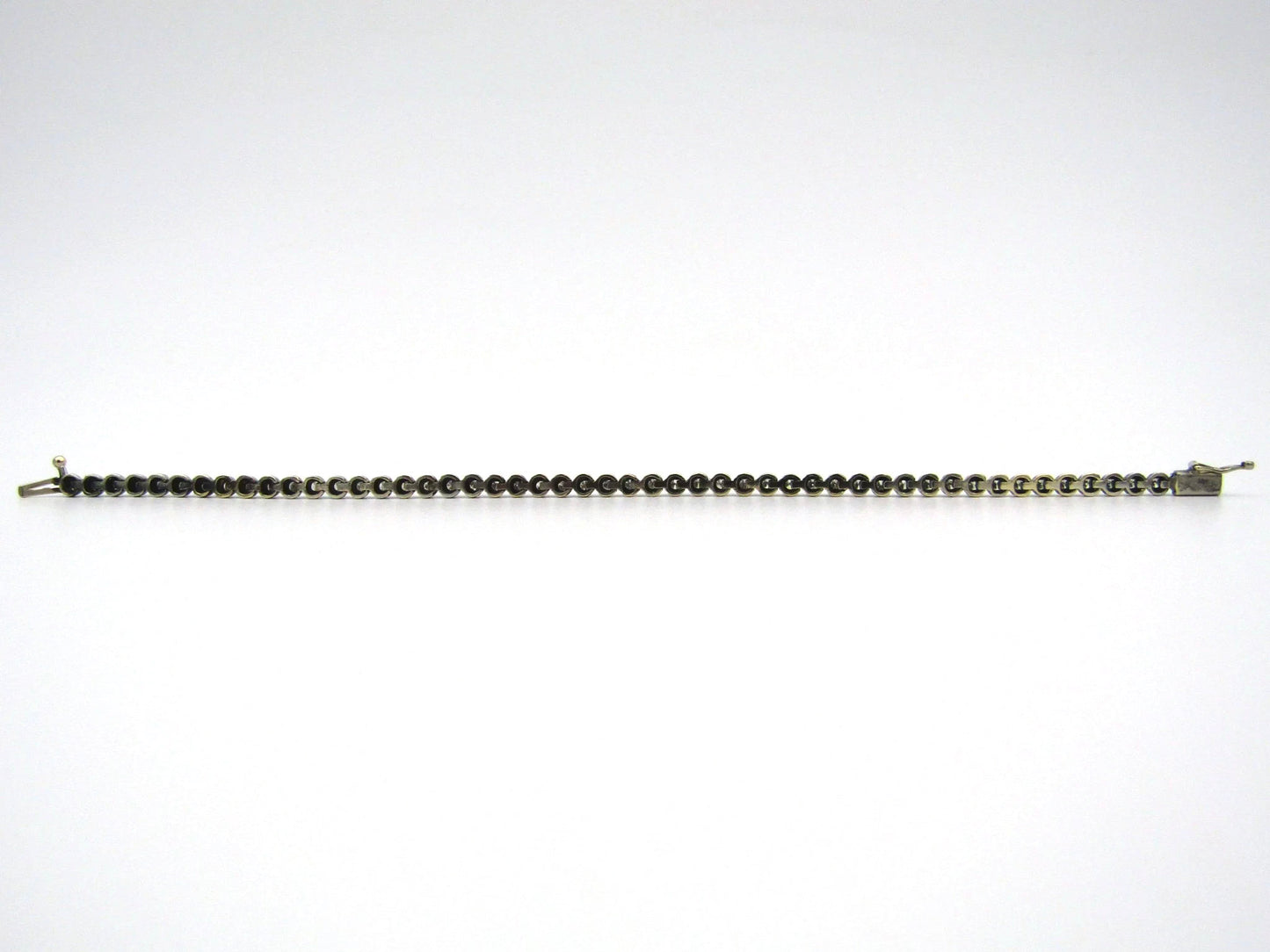 14K gold diamond tennis bracelet.