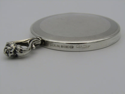 A sterling silver hand mirror by Cartier. Circa 1920s.