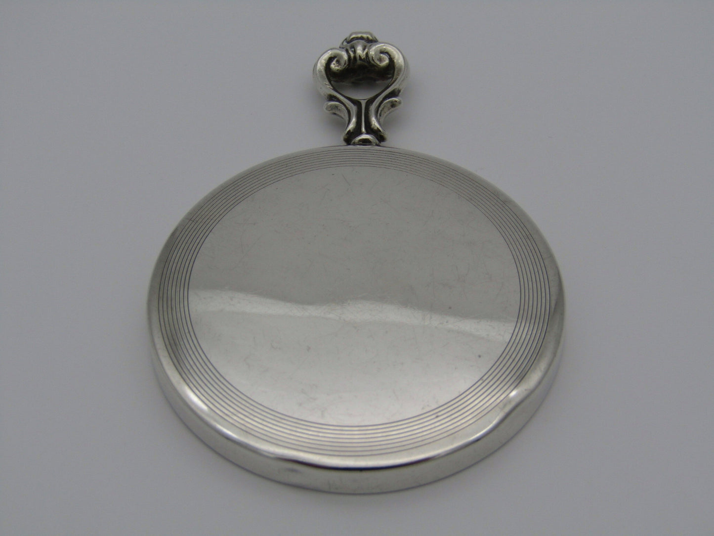 A sterling silver hand mirror by Cartier. Circa 1920s.