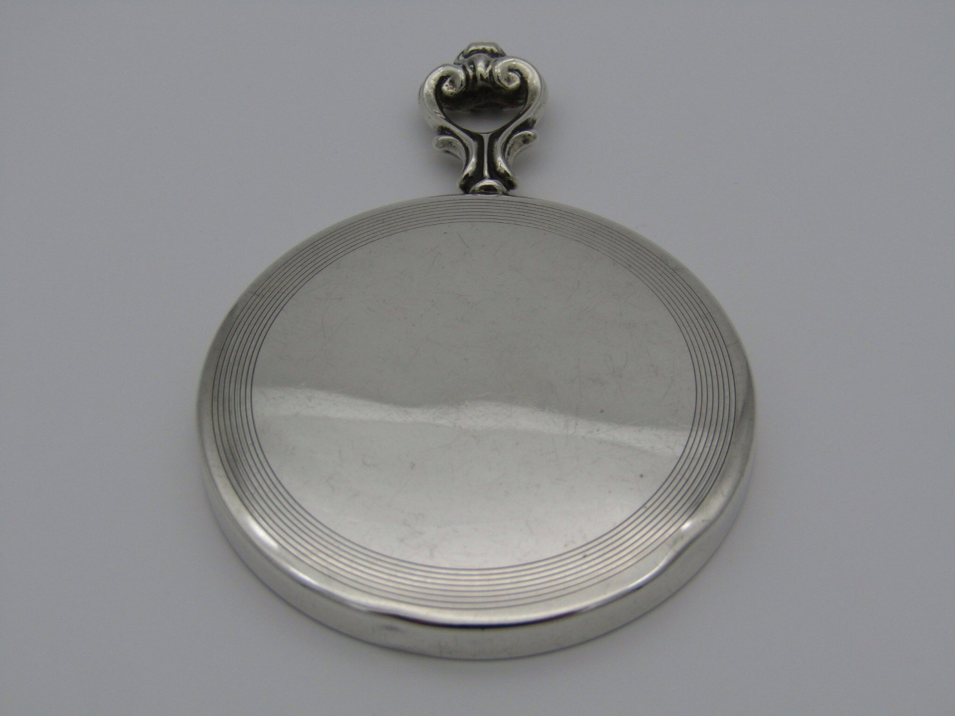 A sterling silver hand mirror by Cartier. Circa 1920s.