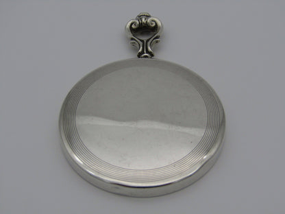 A sterling silver hand mirror by Cartier. Circa 1920s.