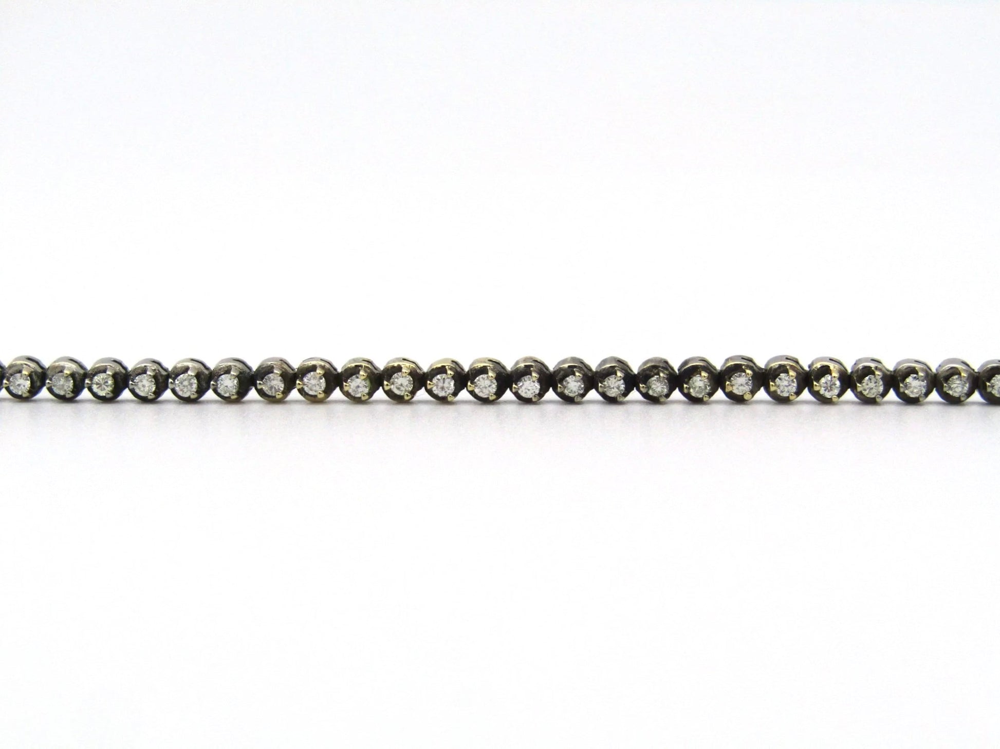 14K gold diamond tennis bracelet.