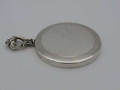 A sterling silver hand mirror by Cartier. Circa 1920s.