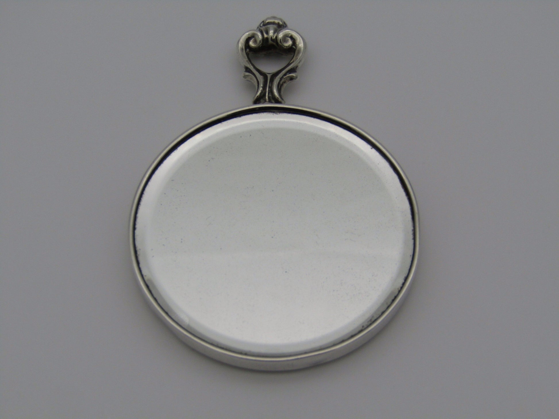 A sterling silver hand mirror by Cartier. Circa 1920s.