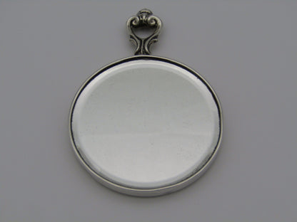 A sterling silver hand mirror by Cartier. Circa 1920s.