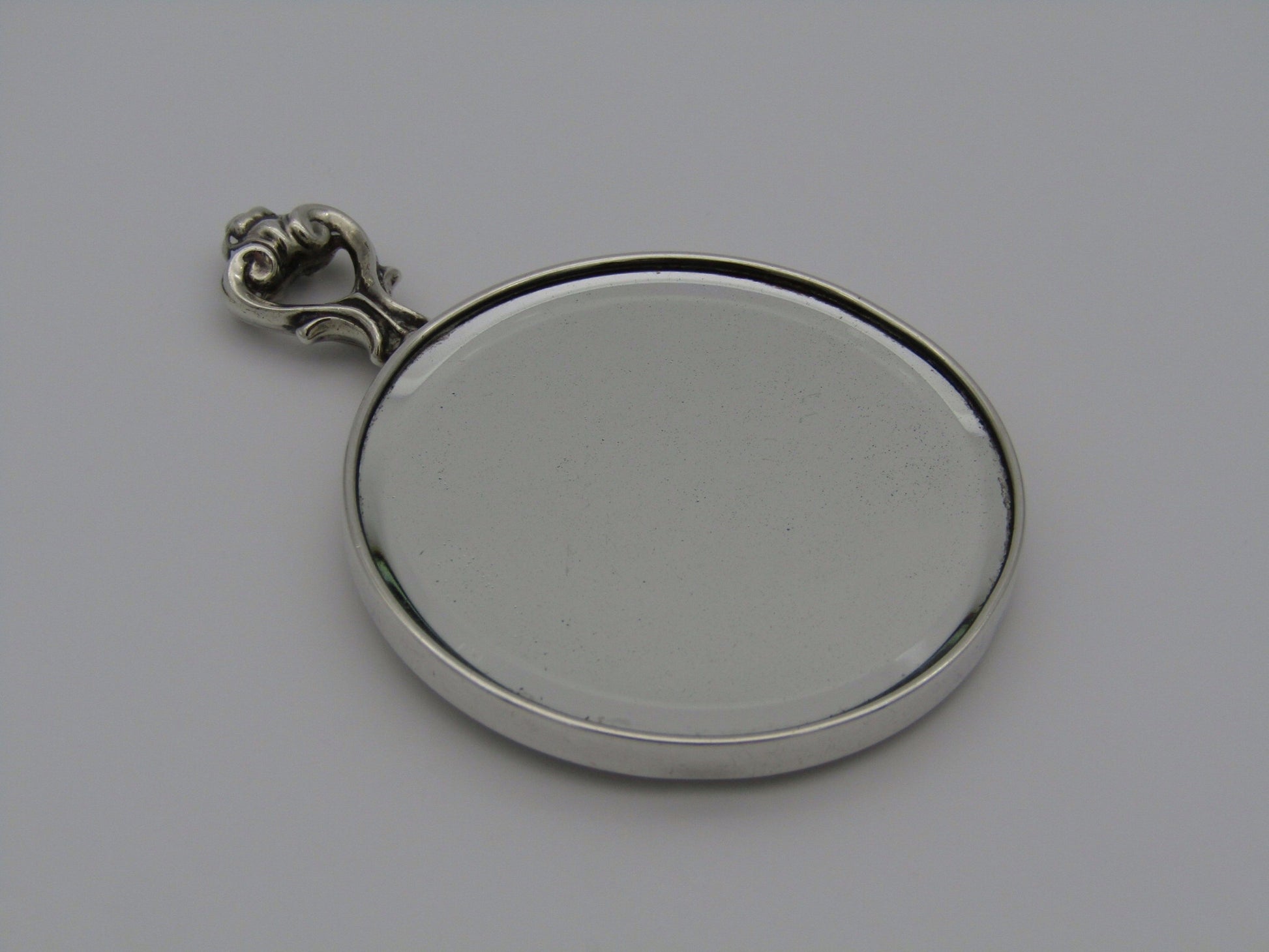 A sterling silver hand mirror by Cartier. Circa 1920s.