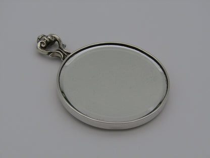 A sterling silver hand mirror by Cartier. Circa 1920s.