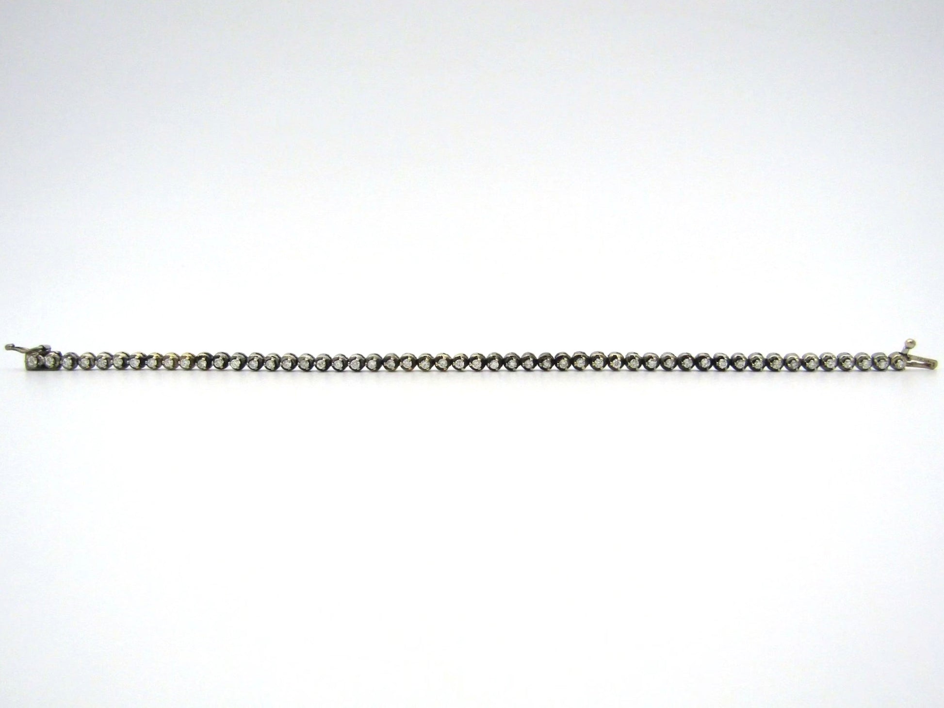 14K gold diamond tennis bracelet.