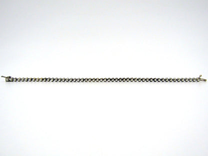 14K gold diamond tennis bracelet.