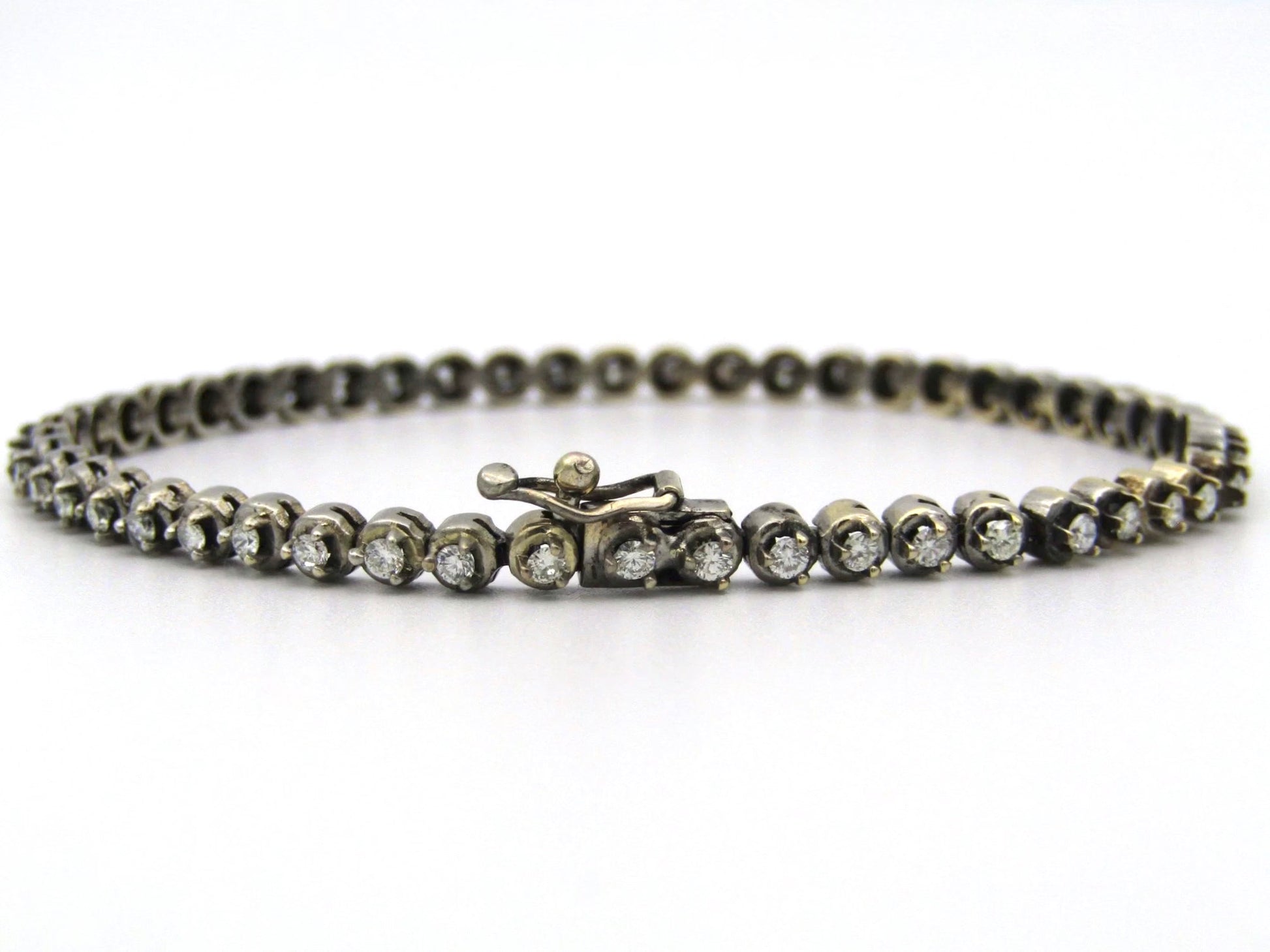 14K gold diamond tennis bracelet.
