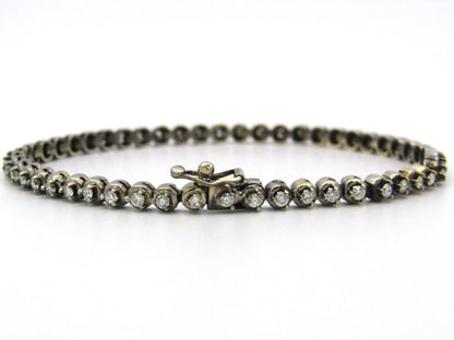 14K gold diamond tennis bracelet.